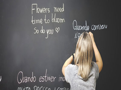 girl writing on chalkboard